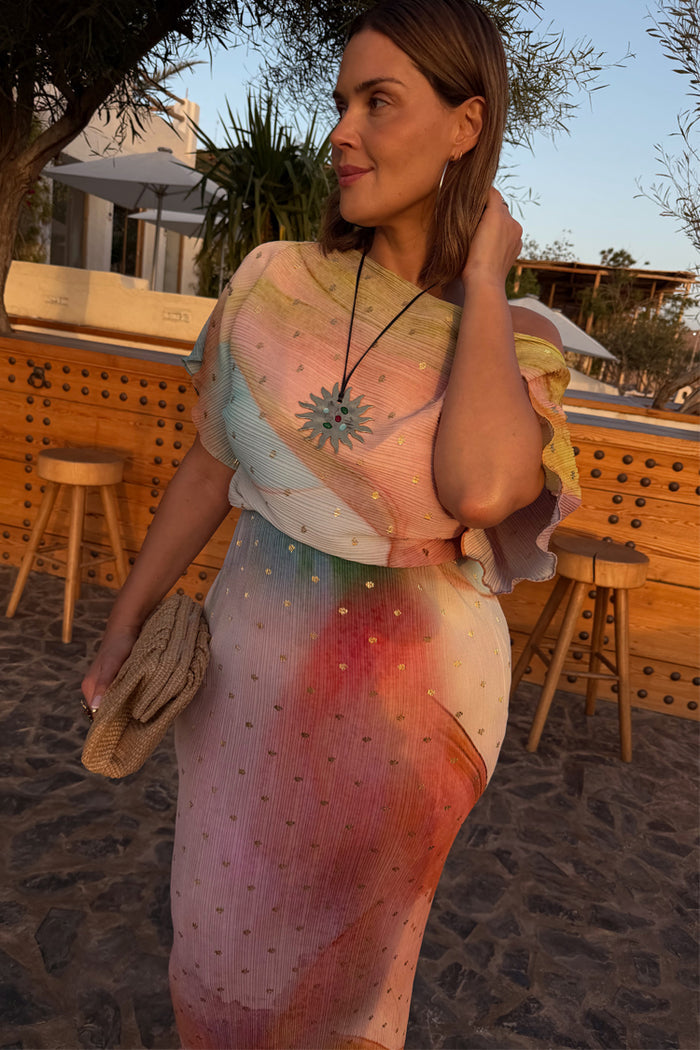 Abstract Tilly midaxi dress with metallic gold fleck print and a fitted skirt, worn by a model in an outdoor setting.