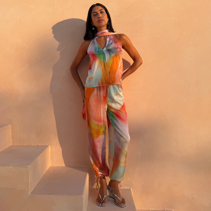 Abstract Naomi Trousers in a bold multicoloured print, with a balloon silhouette, adjustable ankle ties and matching top.