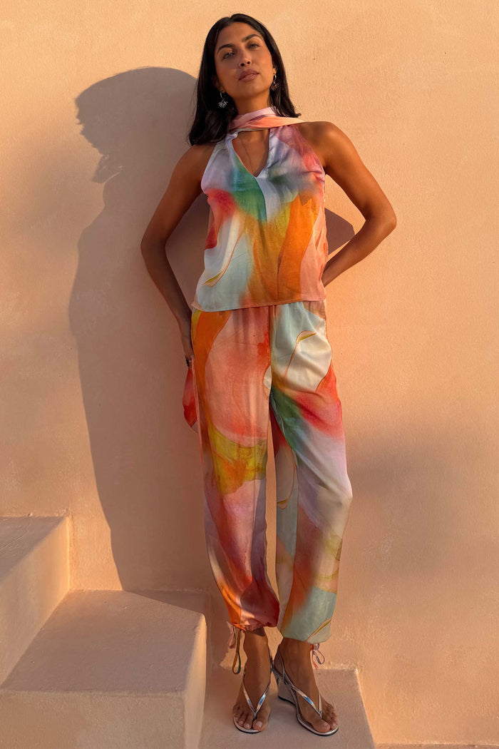 Abstract Naomi Trousers in a multicoloured print with a matching halter top and adjustable balloon leg ties.