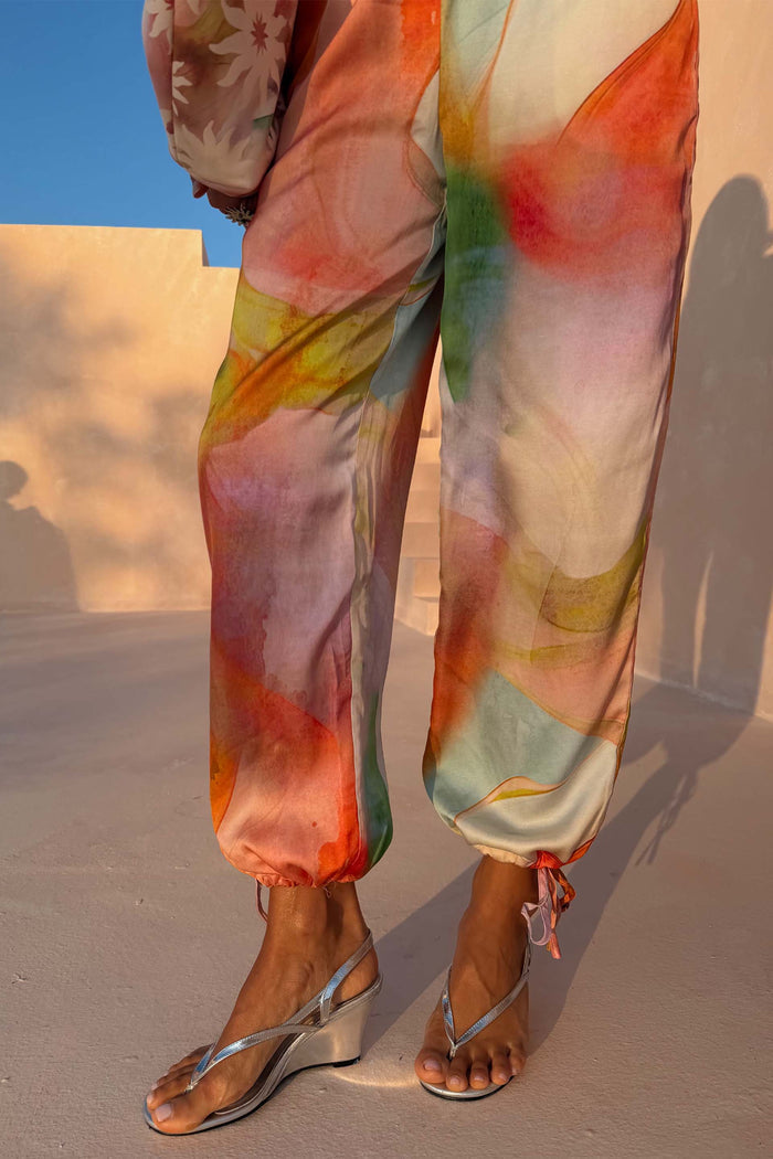 Abstract Naomi Trousers in a multicoloured print with a balloon leg and adjustable ties at the ankles.