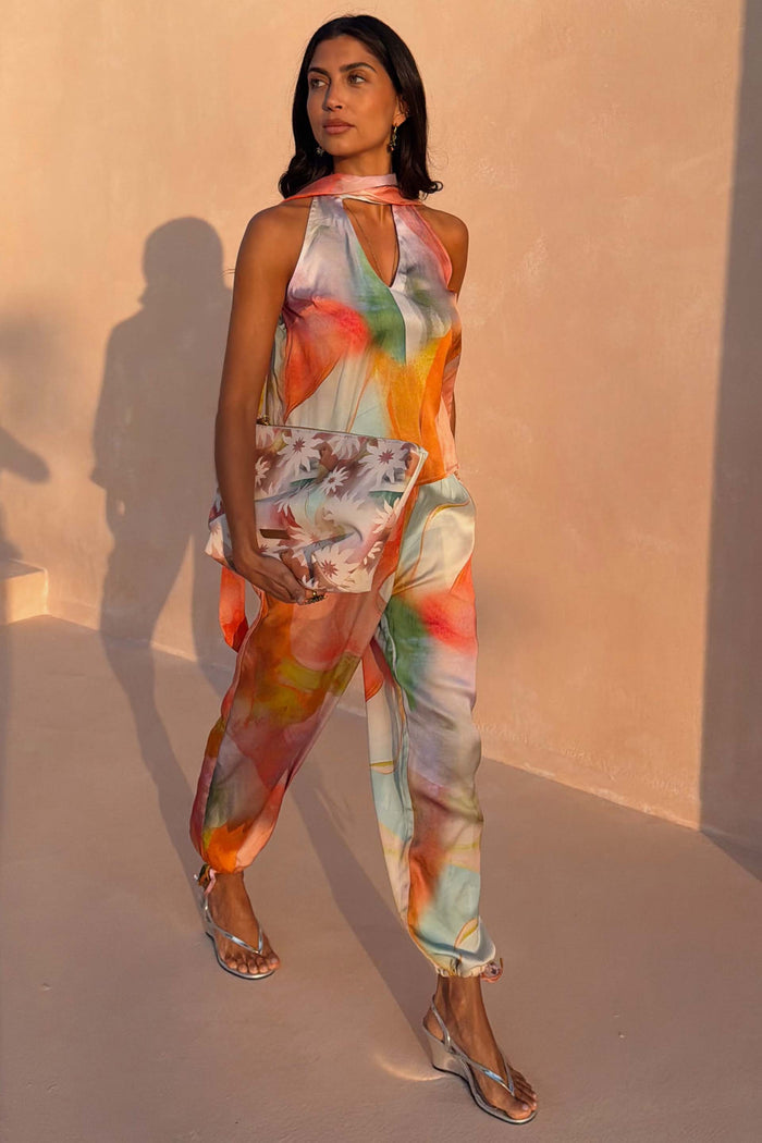Abstract Naomi Trousers in a bold multicoloured print featuring a balloon leg and adjustable ankle ties.