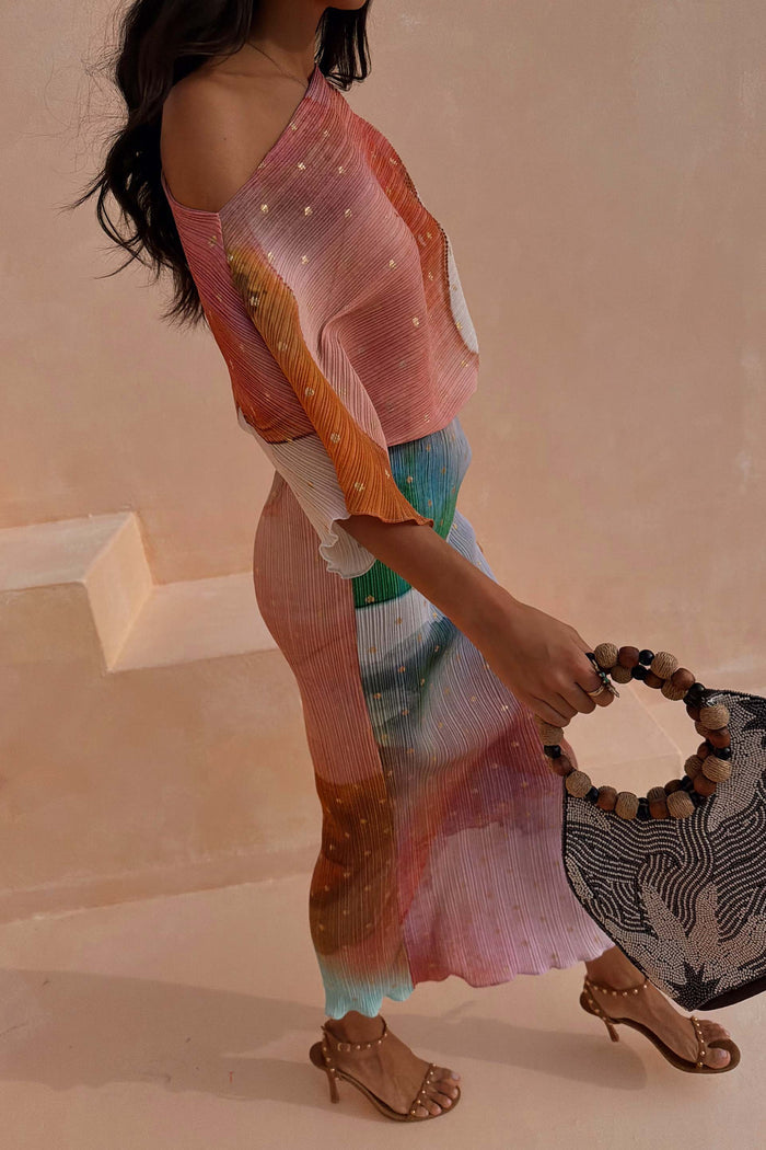 Abstract Tilly Dress featuring a vibrant multicoloured print with gold metallic flecks, styled with a beaded handle bag.