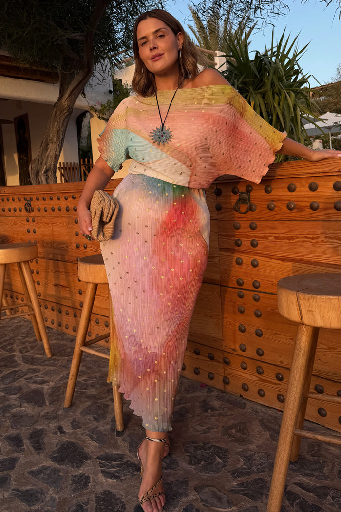 Abstract Tilly midaxi dress featuring a multicoloured pleated print with metallic gold flecks on a model.