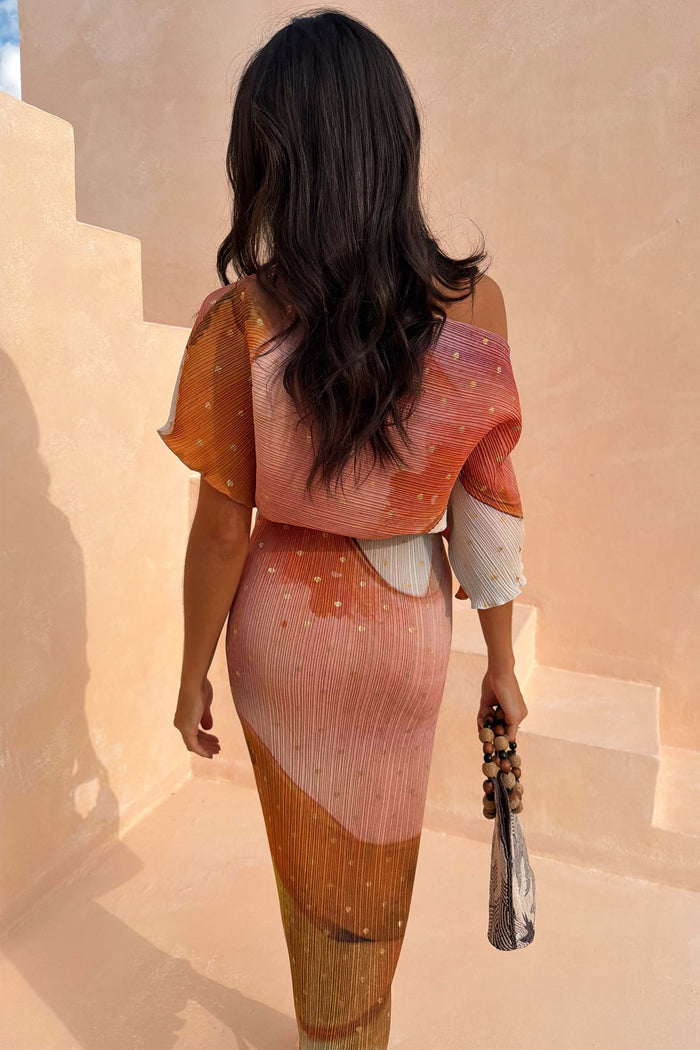 Abstract Tilly Midaxi Dress with gold metallic flecks and a pleated colourful print, seen from the back.