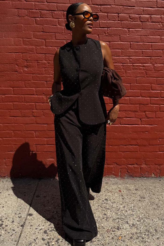 Black Hotfix Marnie Trousers with diamante detail, styled as a co-ord set against a red brick wall.