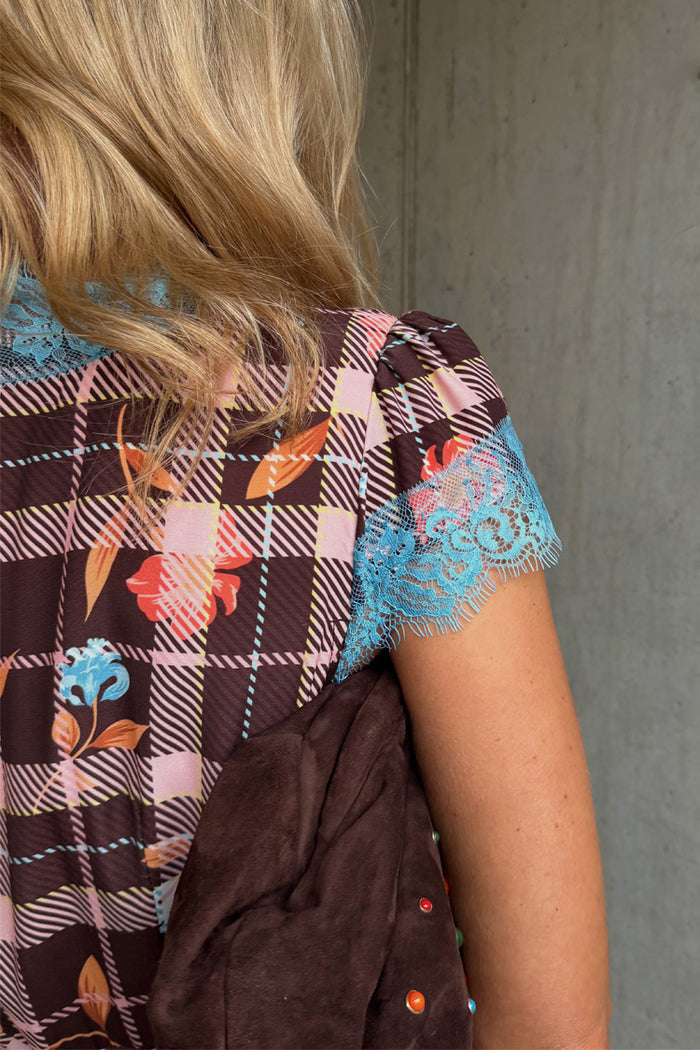 Check Floral Dress detail featuring brown check and floral prints with contrast blue lace at the sleeve and neckline.