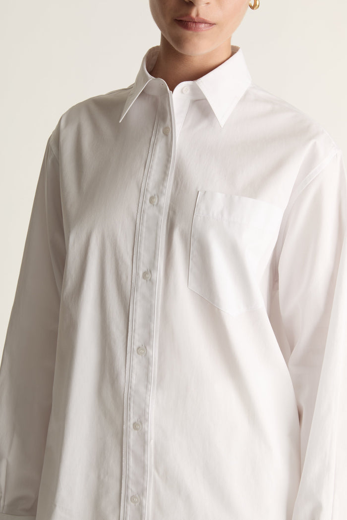 White shirt worn by a person on a plain background