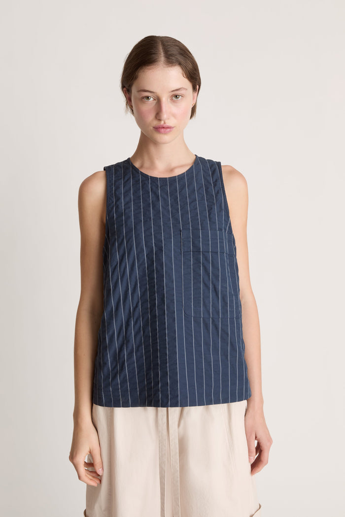 Woman wearing a blue striped dress on a white background