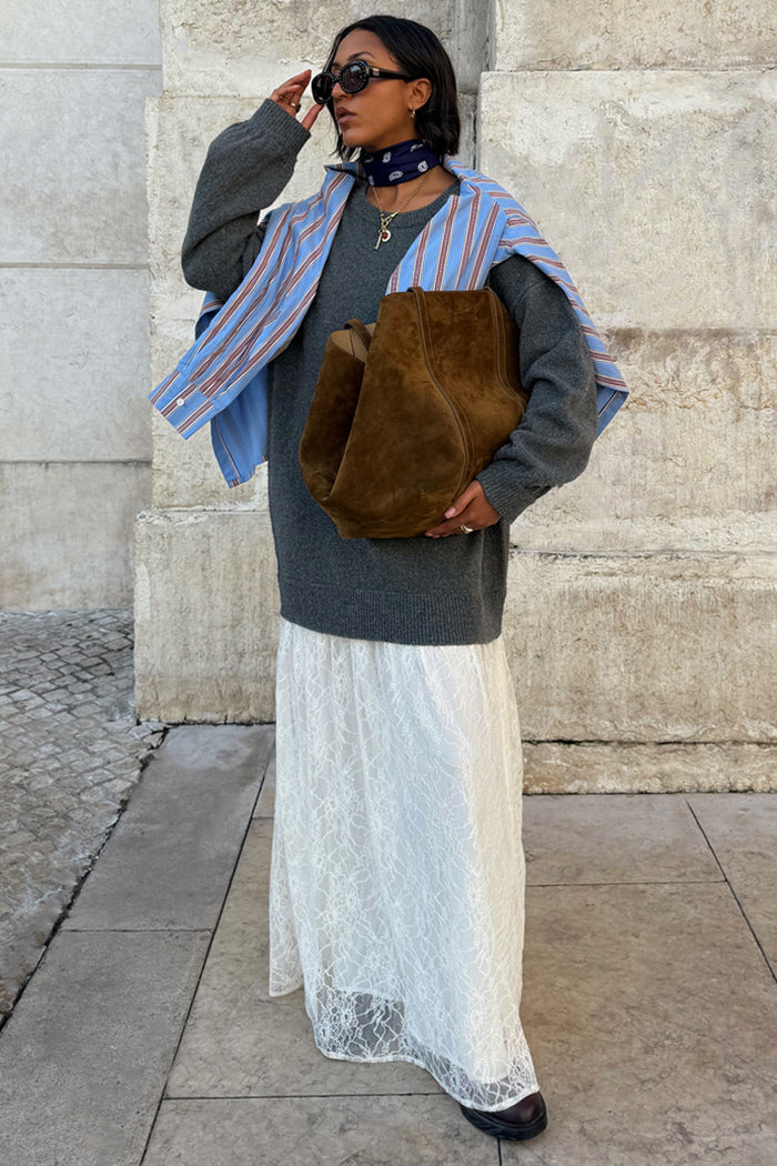 Grey Knit Jumper Dress featuring a sheer white lace skirt, paired with a blue striped shirt and brown suede bag.
