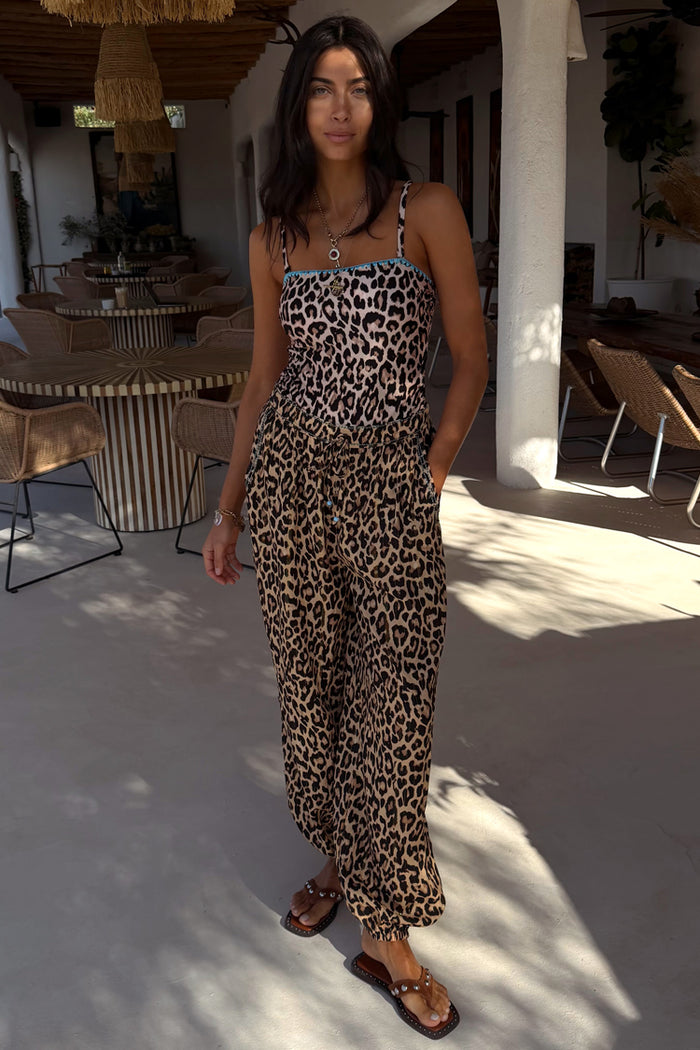 Leopard print swimsuit with blue whipstitch detail and matching balloon trousers for a vacation look.