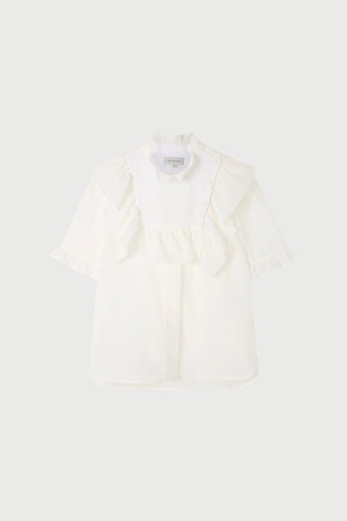 A white top with ruffled sleeves   on a plain background