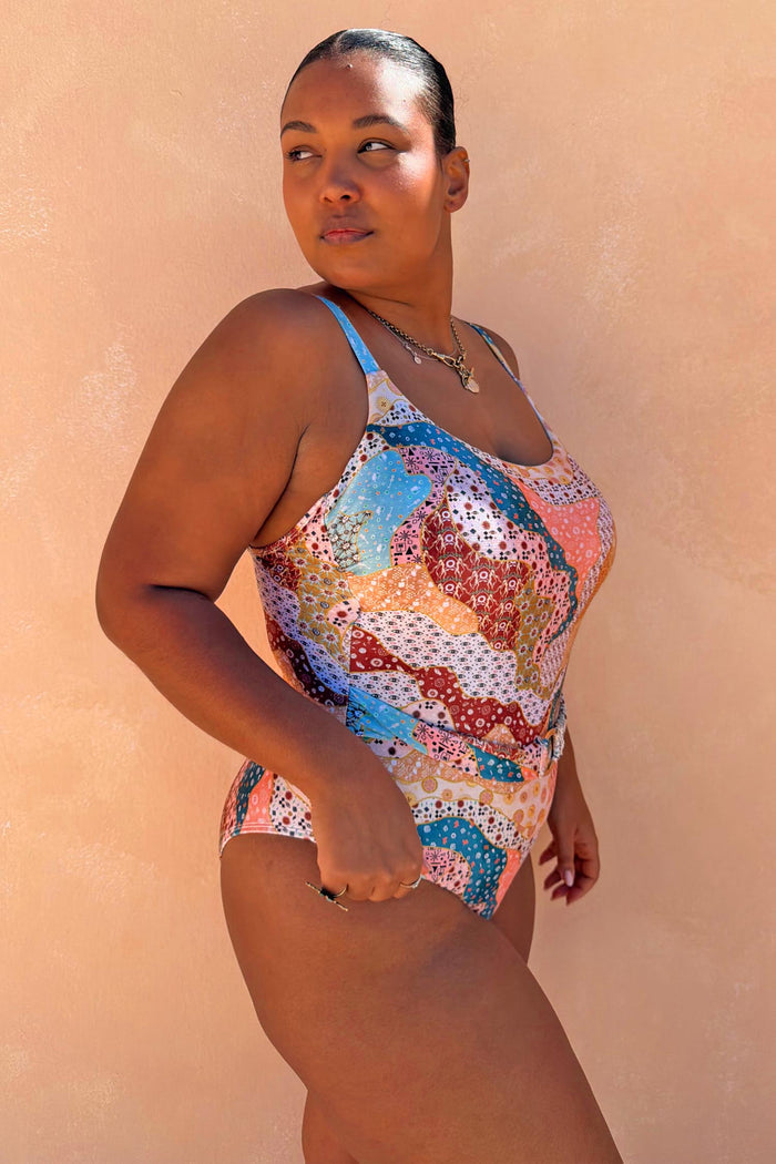 Morocco Swimsuit with a pink and blue patchwork print and belted waist, highlighting inclusive sizing.