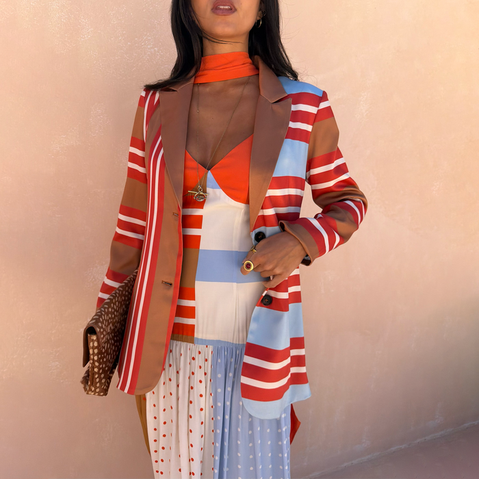 Multi Stripe Blazer in red, blue and tan, featuring a longline fit and styled over a colourful patterned dress.