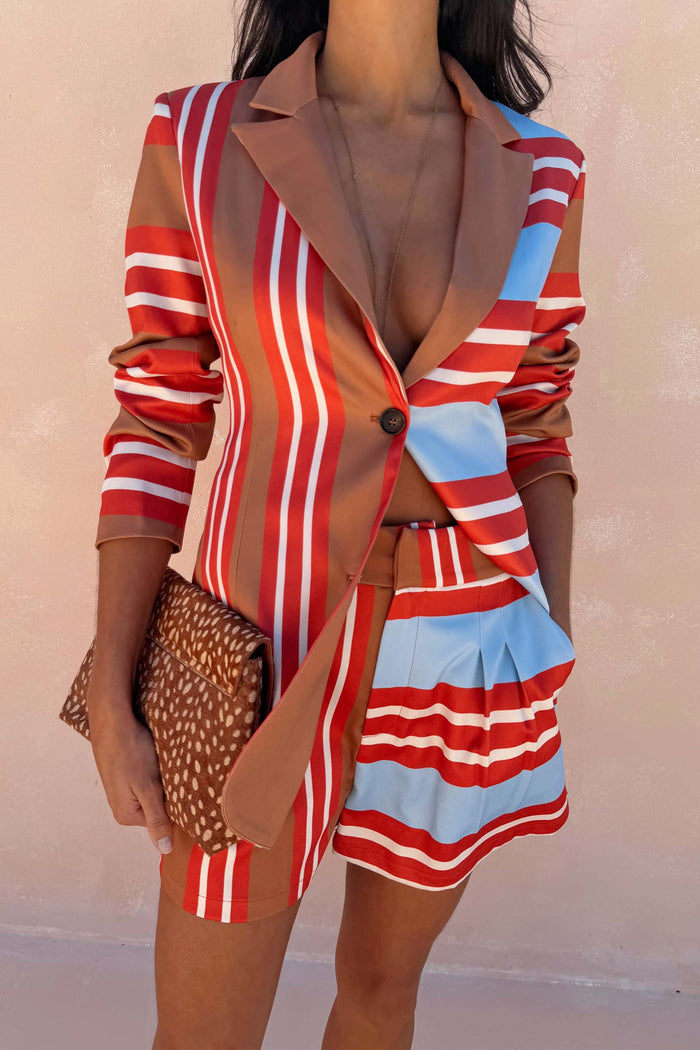 Multi Stripe Blazer in red and blue satin-esque fabric, styled as a co-ord with a leopard print clutch bag.