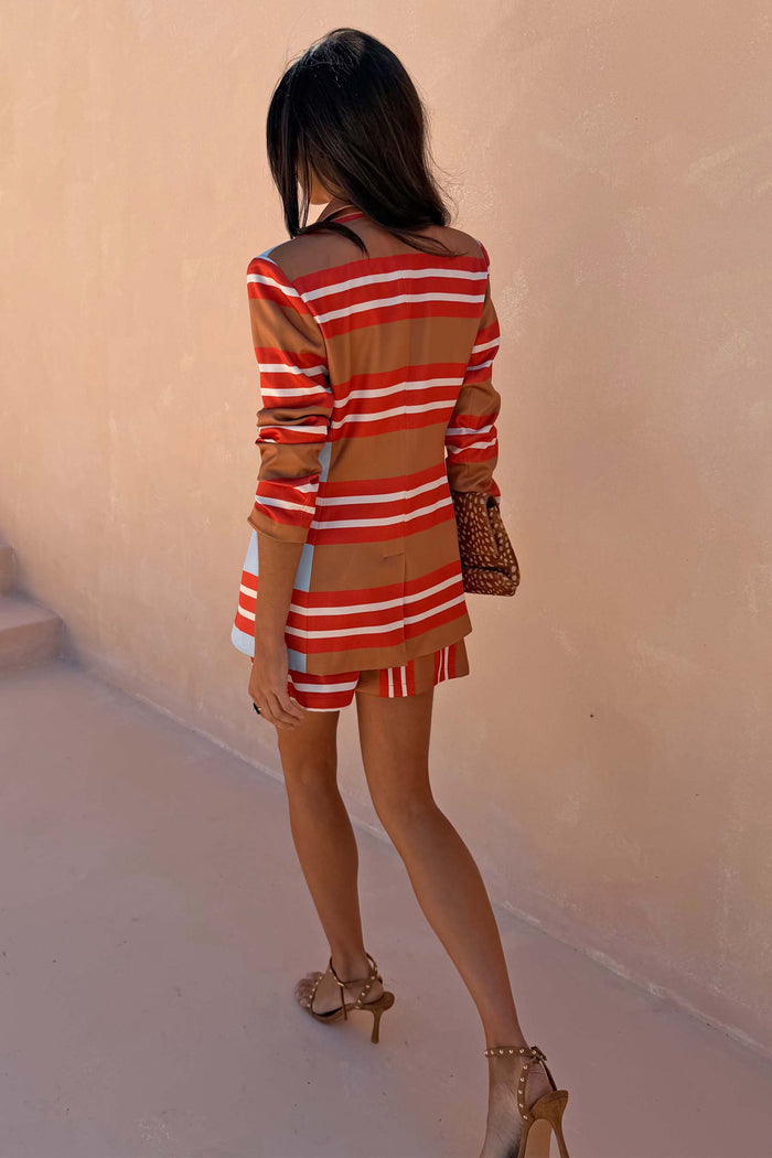 Multi Stripe Blazer in red and blue satin-esque fabric, longline fit, styled with matching shorts and leopard clutch.