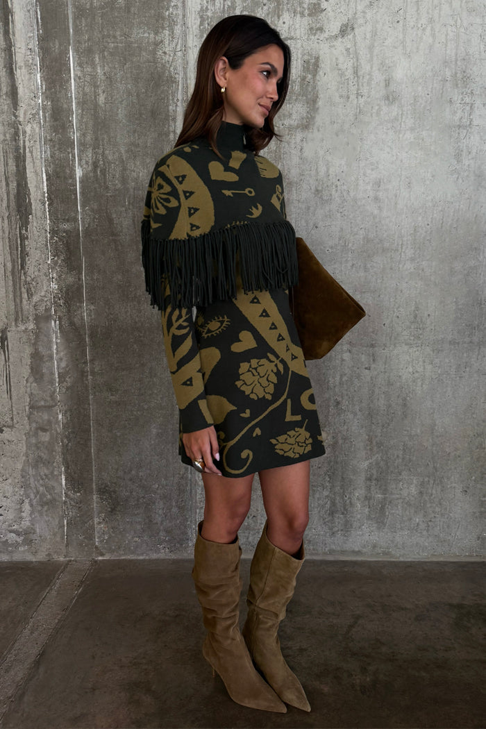 Olive Amara Knit Mini Dress featuring a fringe chest detail and gold motifs, styled with slouchy tan boots.