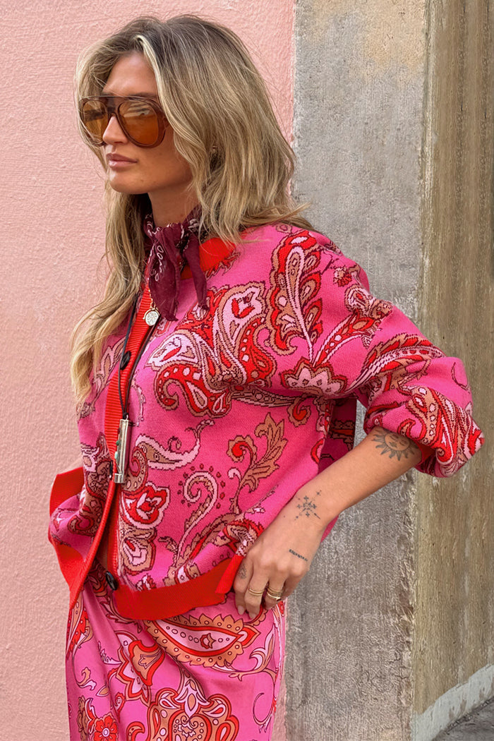 Pink Paisley Oslo Cardigan featuring a paisley print and red ribbed borders in a boxy knit fit.