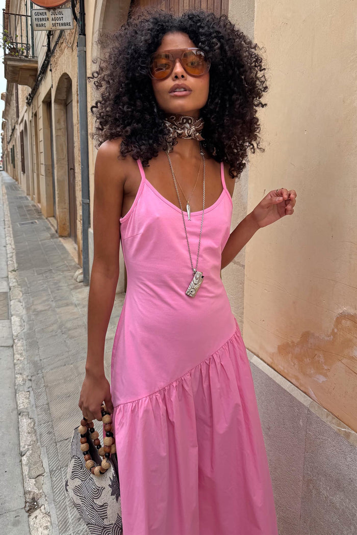 Pink Strappy Nova Dress with a dropped waist and fitted bodice, designed in London for versatile vacation styling.