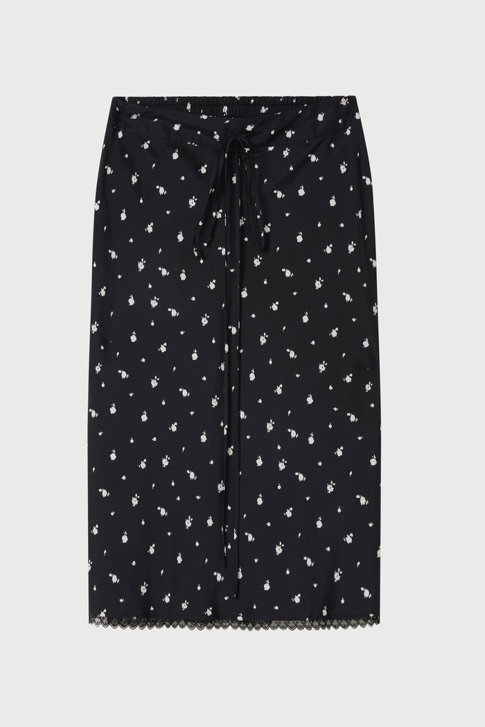 Black skirt with white floral pattern on a light gray background